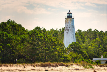 The Georgetown lighthouse on North Island at the end of Winyah bay near Georgetown, South Carolina, USA. - obrazy, fototapety, plakaty