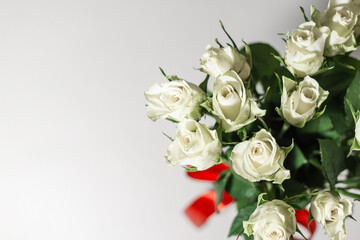 A bouquet of white tea roses on a light table background. Top view. selective focus