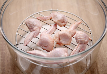 Raw chicken wings in oven