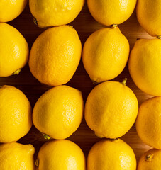 Ripe bright lemons on the dark rustic background. Selective focus. Shallow depth of field.