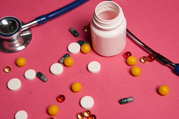 Pills white jar stethoscope health syringe pink background cropped view