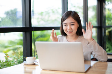 Asian beautiful working woman doing her work and drink in the coffee shop.