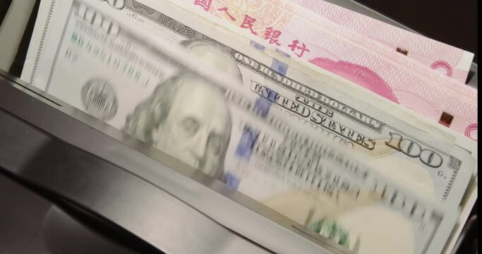US dollar bill vs China yuan, new econ super power. Bank notes in money counter