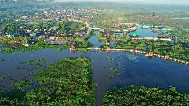 Aerial view video Drone fly over swamp or lake in beautiful sunrise or sunset sky Amazing nature view in the morning at Thale noi Phatthalung