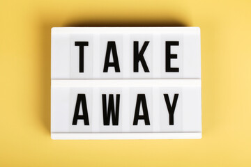 light box with text take away on yellow background , reopening, online, delivery concept