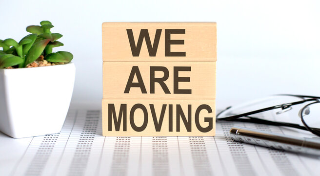 WE ARE MOVING text on the wooden cubes on chart