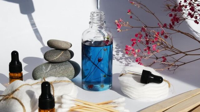Reusable and recycable bathroom accessories on white background. Trendy shadows. Zero waste concept. Natural cosmetics and eco living concept. Essential oil or serum
