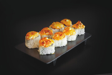 Baked Sushi Roll with fresh salmon, avocado and mussels on top