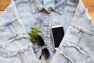 sunglasses ,mobile phone and jacket jeans of fashion lifestyle woman relax arrangement flat lay...
