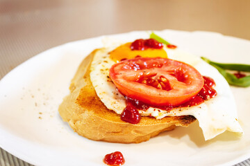 Fried egg with tomato, onion and tomato paste on toast