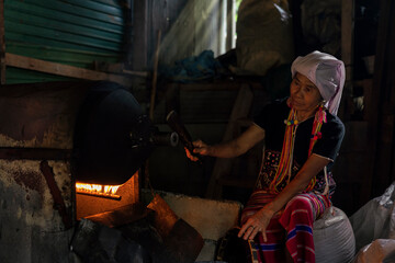 Hill tribe woman roasting coffee. Hill tribe women sorting coffee beans. Old Woman selecting roasted coffee bean. Thailand.