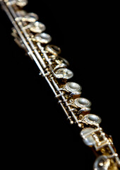 Obraz premium Fragment of a flute on a black background