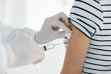 the doctor injects the vaccine into the patient's hand 