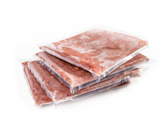 Multiple frozen meat packages in a pile, vacuum sealed. Ground chicken inclusive backs, necks, liver and heart. Concept for raw food diet for cats, dogs and pets. Isolated on white.
