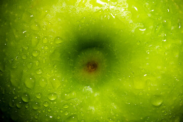 green apple with water drops close-up, fruit background