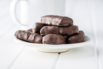Sweet chocolate bars on white plate.
