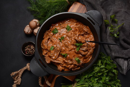 Beef Stroganoff with cremini and champignons on a frying pan.