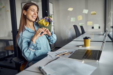 Office worker showing her love for someone via Skype