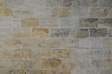 Stones wall background of stone old texture ancient brown facade typical in bordeaux city
