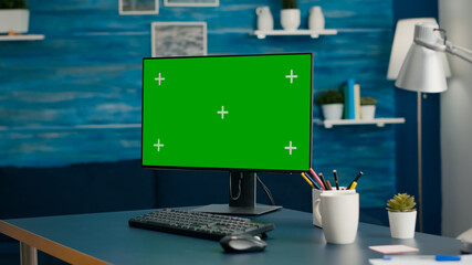 Close up of professional powerful computer with mock up green screen chroma key standing on table...