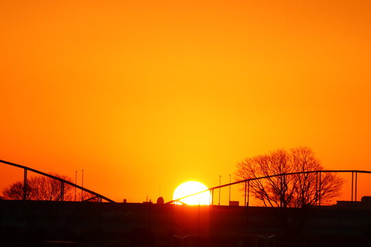 Sunrise through a bridge over the river.