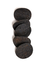 Stack of of black potato chips isolated on white background with copy space. Unusual chips. Unhealthy eat. Junk food. 