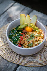 Breakfast Detox Green Smoothie bowls from Green tea and Spinach with fruits, nuts, seeds and  granola and for healthy vegan on the table.