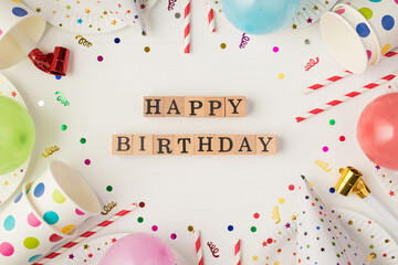 Above photo of cups plate confetti birthday hat party tubules whistle balloons with inscription...