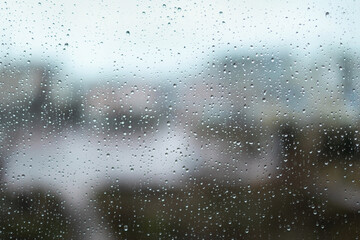 Rain drops on window glass surface. Rainy spring background