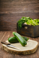 Fresh green zucchini on wooden cutting board