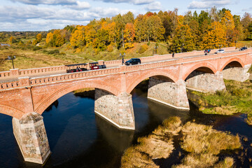 Long brick bridge with train, Kuldiga, Latvia. Captured from above.