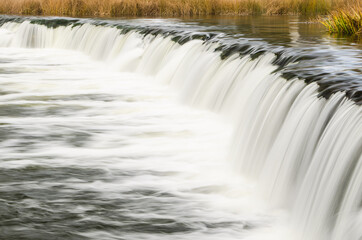 Fototapeta na wymiar Venta waterfall, the widest waterfall in Europe, long exposure photo, Kuldiga, Latvia