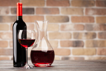 Wine decanter, bottle, glass of red wine