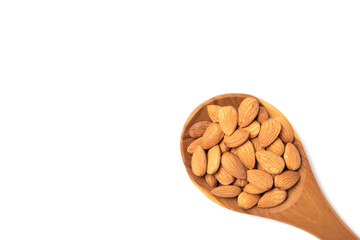 Almond seeds in the wooden spoon on white background.