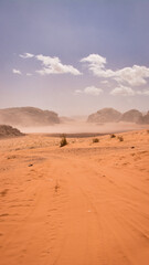 Fototapeta na wymiar Vertical desert off road track leading into the mountains of Waid Rum.