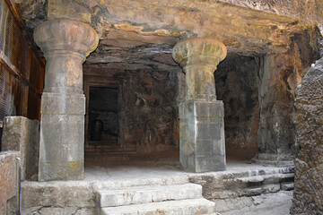 Gigantic pillars of Cave No. 1, Elephanta Cave, entrance towards Shiva Linga at Elephanta Island or Gharapuri, Mumbai, Maharashtra, India