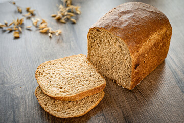 A sliced loaf of sprouted grain and seed bread on a cutting board