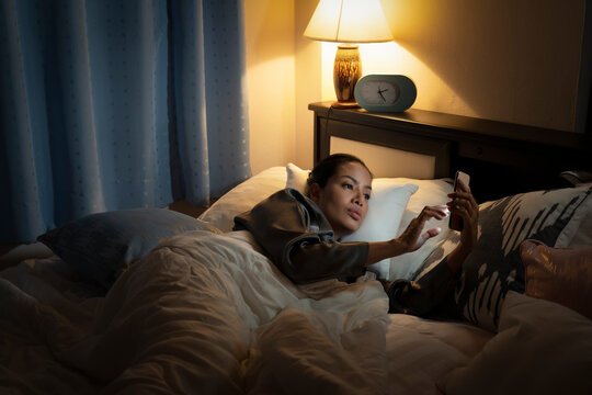 woman people in robe using smart cellphone.Sad Depressed Insomnia girl.