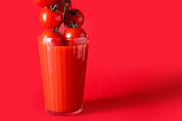 Glass of tasty tomato smoothie on color background
