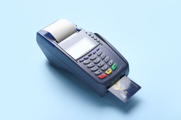 Payment terminal with credit card on color background
