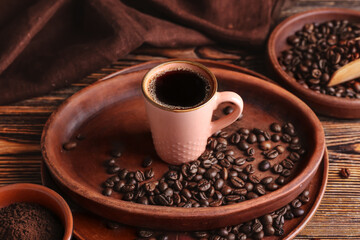 Cup of tasty hot coffee on wooden background