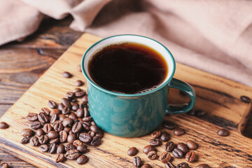 Cup of tasty hot coffee on wooden background