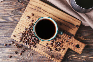 Cup of tasty hot coffee on wooden background