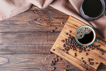 Cup of tasty hot coffee on wooden background
