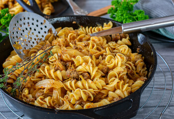 minced meat pan with cabbage and pasta in a skillet