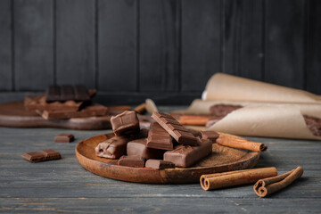 Plate with chocolate on dark background