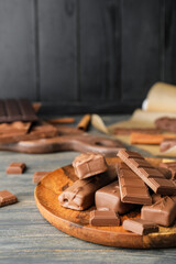 Plate with chocolate on dark background