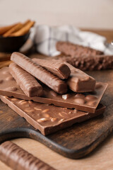 Different chocolate bars on wooden table, closeup