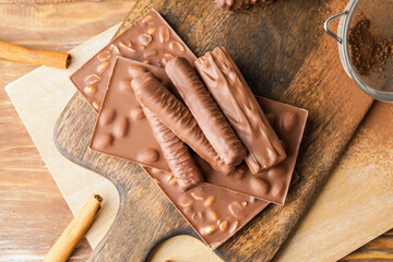 Different chocolate bars on wooden table