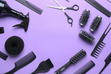 Frame made of hairdresser's tools on color background
